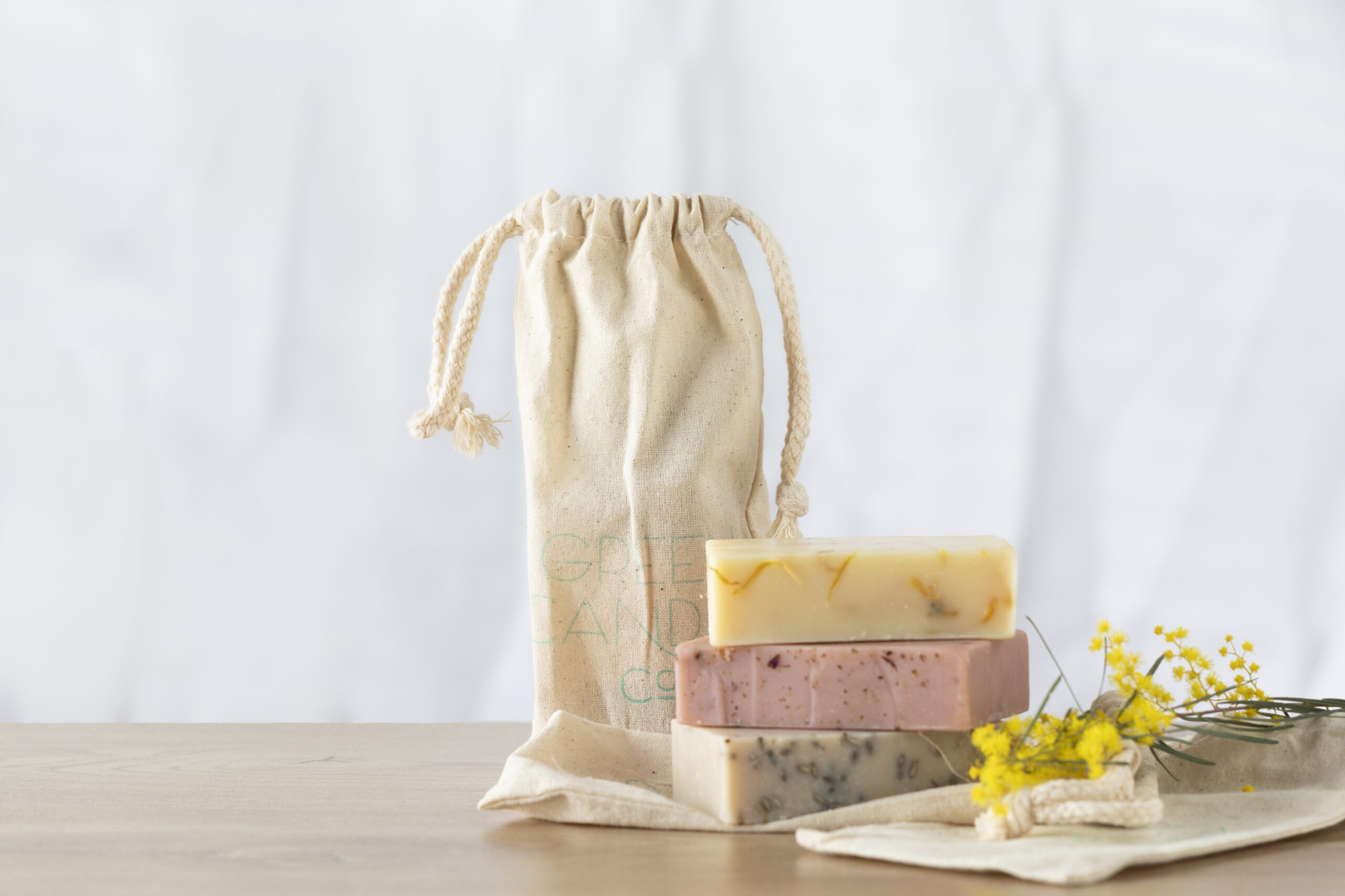 Three bars of handmade soap on bench