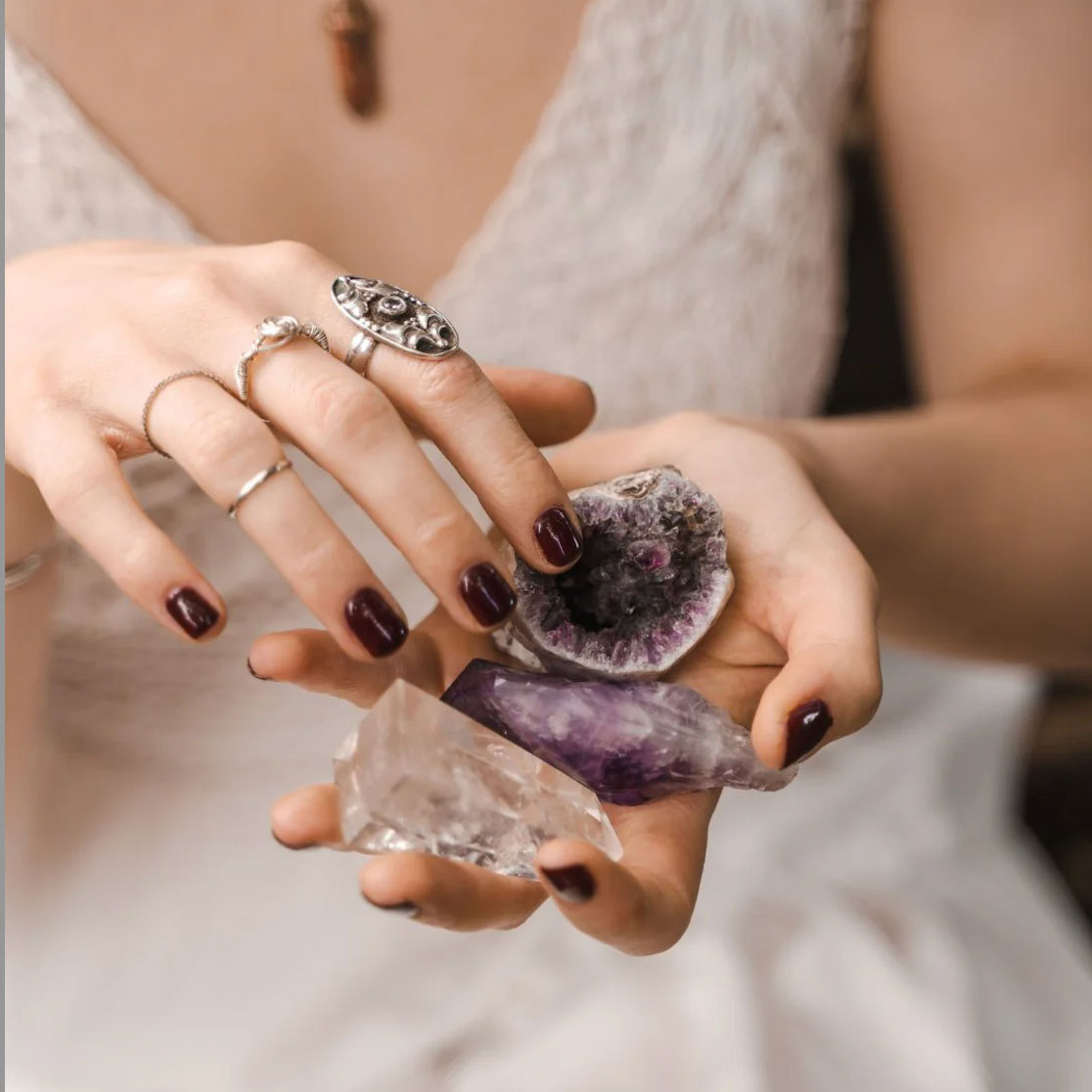 woman holding two crystals in hand