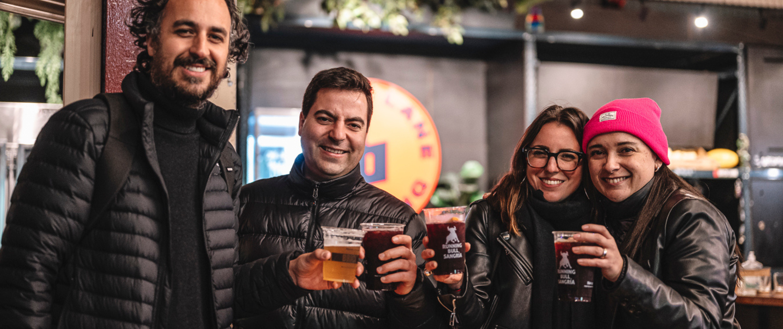 friends holding a few drinks and cheers